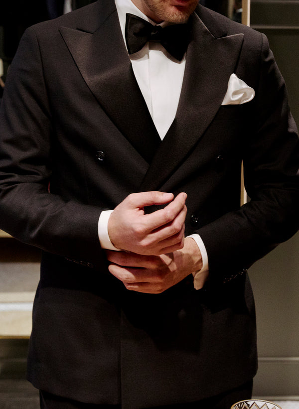 A tuxedo close up showing the details of a bow tie and pocket square.