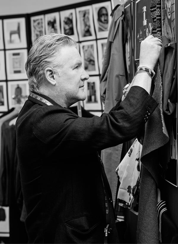 Todd Snyder is shown evaluating swatches against his designs.