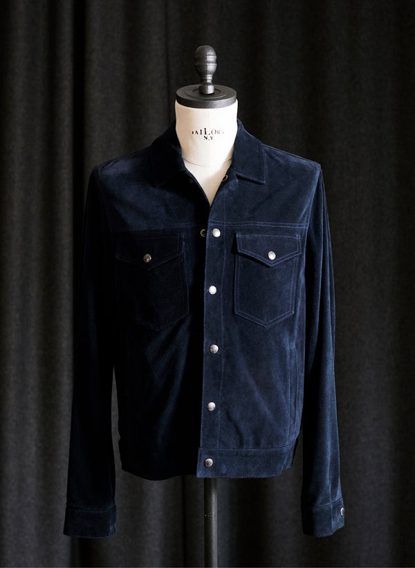A suede jacket is displayed on a form, highlighting the craftsmanship and quality of the jacket.